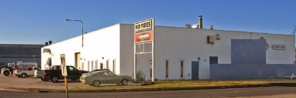 1 Mo-Tires Ltd building exterior with signage, showcasing automotive services and tire shop in Lethbridge, Alberta.